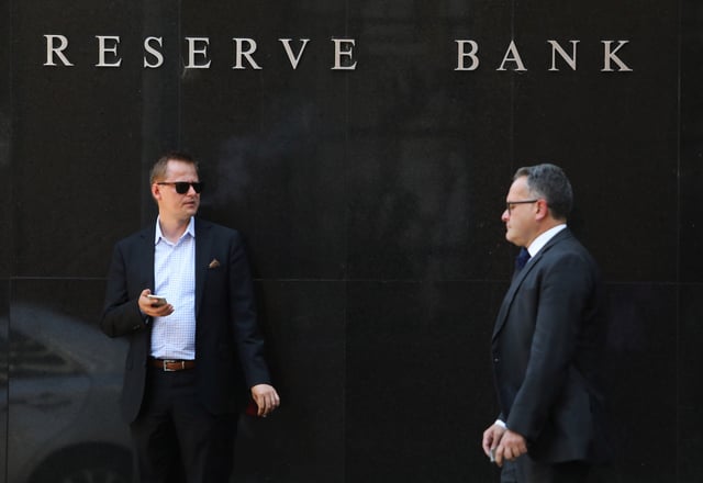A man smokes next to the Reserve Bank of Australia headquarters in central Sydney, Australia February 6, 2018. REUTERS/Daniel Munoz/File Photo