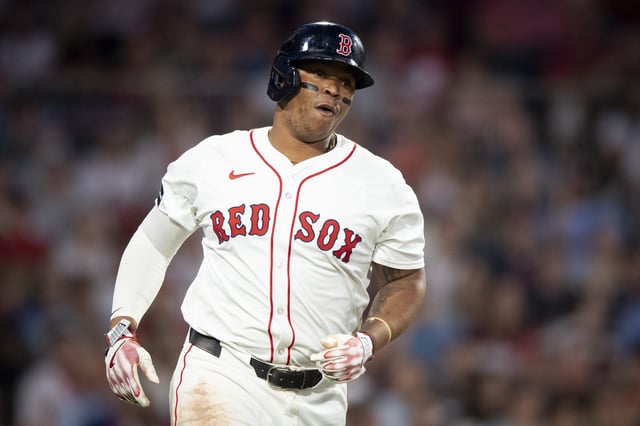 BOSTON, MA - JUNE 13: Rafael Devers #11 of the Boston Red Sox runs after hitting a single during the fourth inning of a game against the Philadelphia Phillies on June 13, 2024 at Fenway Park in Boston, Massachusetts.