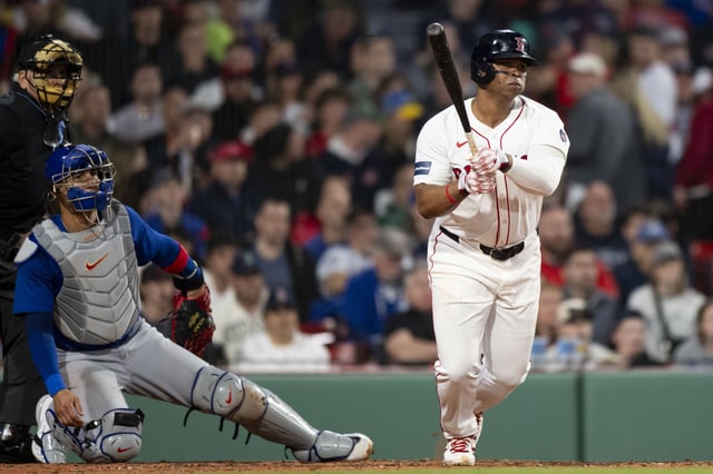 BOSTON, MA - APRIL 28: Rafael Devers #11 of the Boston Red Sox hits a single during the third inning against the Chicago Cubs on April 28, 2024 at Fenway Park in Boston, Massachusetts.