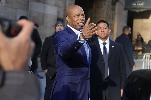 New York City mayor Eric Adams, center, talks to someone as he leaves an event in New York, Thursday, Jan. 30, 2025. (AP Photo/Seth Wenig)