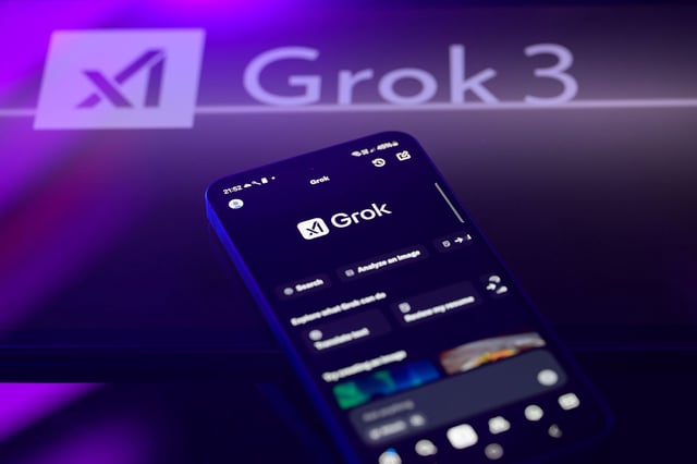 The Grok X AI app displays on a mobile phone with the Grok X AI logo, as seen in this photo illustration in Brussels, Belgium, on February 16, 2025.