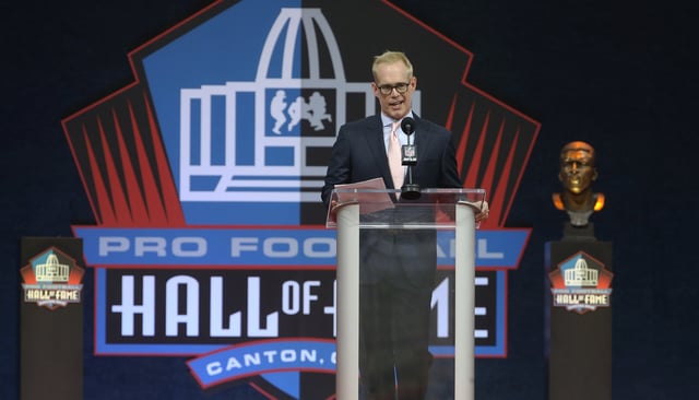 Aug 7, 2021; Canton, Ohio, USA;  Broadcaster Joe Buck accepts the 2020 Pete Rozelle Award during the Professional Football HOF enshrinement ceremonies at Tom Benson Hall of Fame Stadium. Mandatory Credit: Charles LeClaire-USA TODAY Sports/File Photo