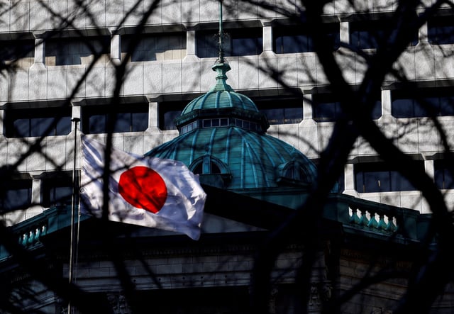 Japanese national flag hoisted atop of the Bank of Japan headquarters is seen through trees in Tokyo, Japan January 23, 2025.  REUTERS/Issei Kato/File Photo
