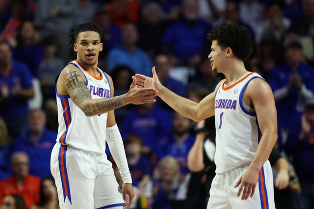 Florida guards Will Richard, left, Walter Clayton Jr. slap five during the No. 2 Gators’ rout of Oklahoma Tuesday night at the Stephen C. O’Connell Center in Gainesville. (Photo by James Gilbert/Getty Images)