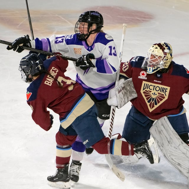 Montreal Victoire Alexandra Labelle (13) struggles to get the puck in front of Montreal Victoire Elaine Chuli (20) and Montreal Victoire Cayla Barnes (3)  during first period PWHL hockey action in Laval, Que. Tuesday Feb. 18, 2025. THE CANADIAN PRESS/Peter McCabe