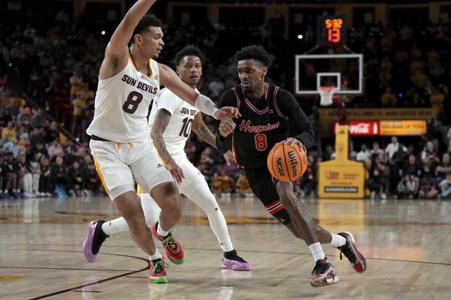 Houston guard Mylik Wilson drives past Arizona State forward Basheer Jihad (8) and guard BJ Freeman during the first half of an NCAA college basketball game, Tuesday, Feb. 18, 2025, in Tempe, Ariz. (AP Photo/Rick Scuteri)