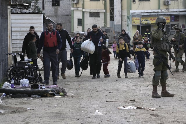 Residents of the West Bank refugee camp of al-Far'a, near Tubas, evacuate their homes as the Israeli military operation continues in the area on Saturday, Feb. 8, 2025. (AP Photo/Majdi Mohammed)