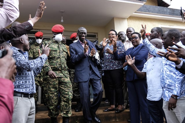 FILE - Ugandan opposition leader and four-time presidential candidate Kizza Besigye, center left, reacts as he arrives at the Makindye Martial Court in Kampala, Uganda, Nov. 20. 2024. (AP Photo/Hajarah Nalwadda, File)