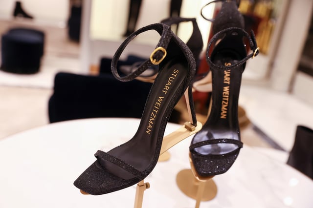 Shoes are seen for sale in a Stuart Weitzman store, owned by Tapestry, Inc., in Manhattan, New York, U.S., November 19, 2021. REUTERS/Andrew Kelly/File Photo