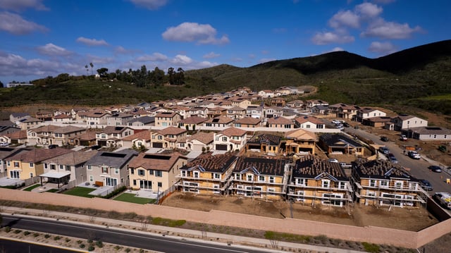 A drone view shows single-family homes at a new subdivision under construction in the rural hills of San Marcos, California, U.S., March 25, 2024.  REUTERS/Mike Blake/File Photo