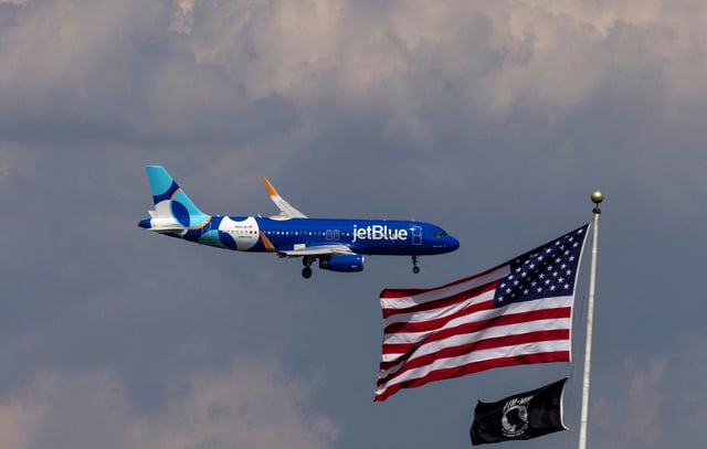 A JetBlue Airlines commercial aircraft flies over Washington as it approaches to land at Dulles International Airport, as seen from Washington, U.S., August 5, 2024. REUTERS/ Umit Bektas/File Photo