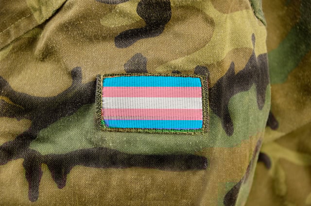 Cropped closeup shot of a transgender flag on a soldier's uniform (via Getty Images)