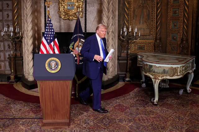 U.S. President Donald Trump walks at Mar-a-Lago in Palm Beach, Florida, U.S., February 18, 2025. REUTERS/Kevin Lamarque