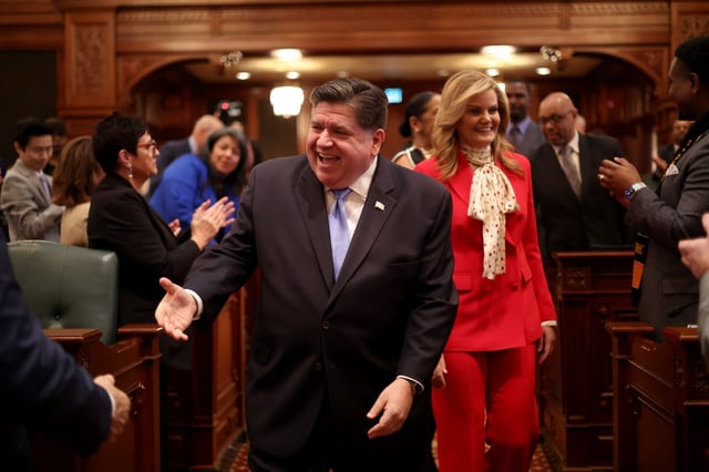 Governor JB Pritzker walks the floor before delivering his State of the State and budget address before the General Assembly at the Illinois State Capitol, Feb. 19, 2025. (Brian Cassella/Chicago Tribune)