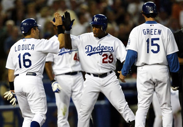 Adrian Beltre #29 of the Los Angeles Dodgers is congratulated by Paul Lo Duca #16 and Shawn Green #15 after all scored on Beltre&#39;s three run home run in the third inning against the Arizona Diadmondbacks on May 29, 2004 at Dodger Stadium in Los Angeles.