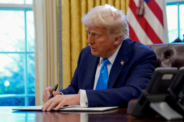 U.S. President Donald Trump signs a document in the Oval Office at the White House in Washington, U.S. February 4, 2025. REUTERS/Elizabeth Frantz/File Photo
