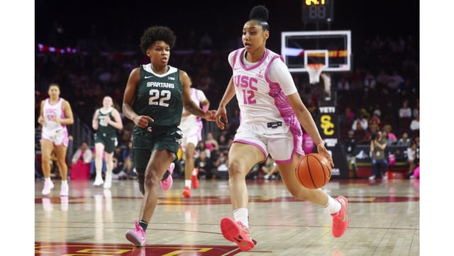 USC guard JuJu Watkins drives as Michigan State guard Nyla Hampton defends during the second half of their Big Ten game on Wednesday night at the Galen Center. Watkins had 28 points, eight rebounds, three assists, three steals and three blocked shots as the fourth-ranked Trojans held off the No. 22 Spartans, 83-75. (AP Photo/Jessie Alcheh)