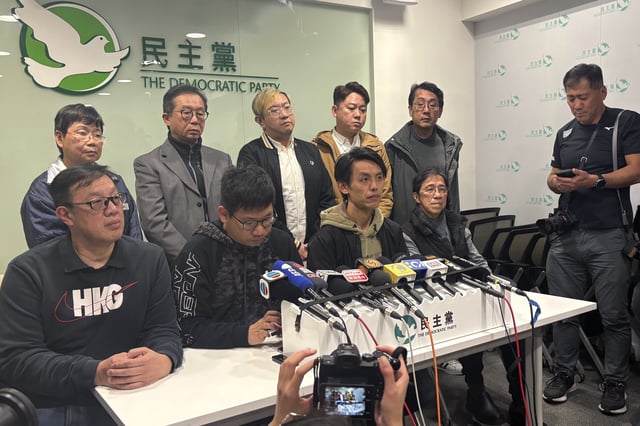 Lo Kin-hei, chairperson of Hong Kong's Democratic Party, seated, second from right, attends a press conference held at the office of Hong Kong's Democratic Party In Hong Kong on Thursday, Feb. 20, 2025. (AP Photo/Kanis Leung)