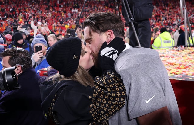 Taylor Swift kisses Travis Kelce #87 of the Kansas City Chiefs after the Chiefs defeated the Buffalo Bills 32-29 to win the AFC Championship Game at GEHA Field at Arrowhead Stadium on January 26, 2025 in Kansas City, Missouri.