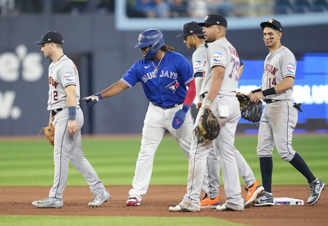 TORONTO, ON - JUNE 5: Vladimir Guerrero #27 of Toronto Blue Jays pokes Alex Bregman #2 of Houston Astros in a break in play during the seventh inning in their MLB game at the Rogers Centre on June 5, 2023 in Toronto, Ontario, Canada.