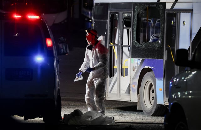 Forensic personnel inspects the area where a bus exploded, in Bat Yam, south of Tel Aviv, Israel.
