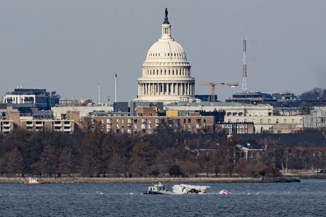 Emergency response units work at the crash site of the American Airlines plane on the Potomac River after the plane crashed last night on approach to Reagan National Airport on January 30, 2025 in Arlington, Virginia.