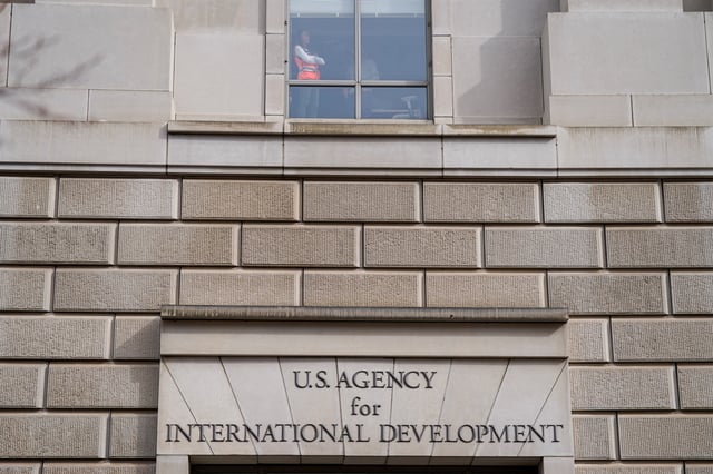 A worker looks out of the window of the U.S. Agency for International Development (USAID) building, after billionaire Elon Musk, who is heading U.S. President Donald Trump's drive to shrink the federal government, said work is underway to shut down the U.S. foreign aid agency USAID, in Washington, U.S., February 3, 2025. REUTERS/Kent Nishimura
