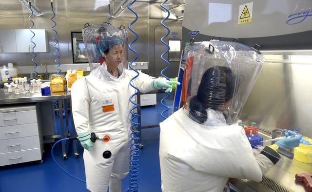 Virologist Shi Zheng-li, left, works with her colleague in the P4 lab of Wuhan Institute of Virology (WIV) in Wuhan in central China&#39;s Hubei province Thursday, Feb. 23, 2017