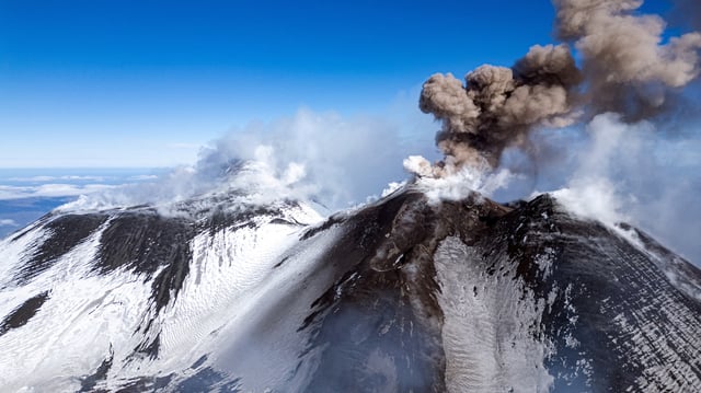 Volcanic steam and ashes rise from Mount Etna, Italy, February 12, 2025. REUTERS/Etna Walk/Giuseppe Di Stefano/File Photo