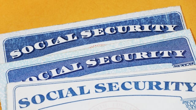 Stock image/file photo: Social Security cards on a yellow background.