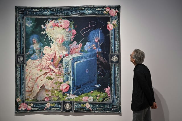 A person looks at AI artwork created by Grimes, Mac Boucher, Mary Jacobo and Eurypheus called ‘Marie Antoinette After the Singularity #2’