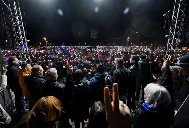 Demonstrators hold up their phones with flashlights on during an anti-government protest in Bratislava, Slovakia, February 21, 2025. REUTERS/Radovan Stoklasa