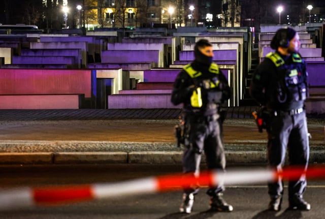 Police officers work at the cordoned off scene where a person was stabbed near the at the Holocaust Memorial, in Berlin on Feb. 21, 2025.