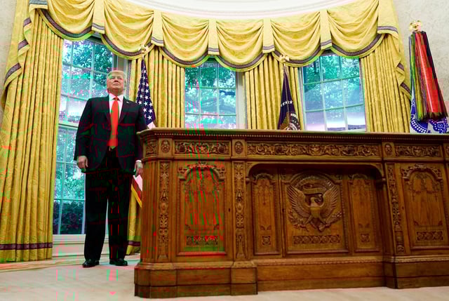 President Donald Trump stands beside the Resolute Desk in the Oval Office during during a presentation of the Presidential Medal of Freedom to NBA Hall of Famer Jerry West at the White House in Washington, D.C. on Sept. 5, 2019.