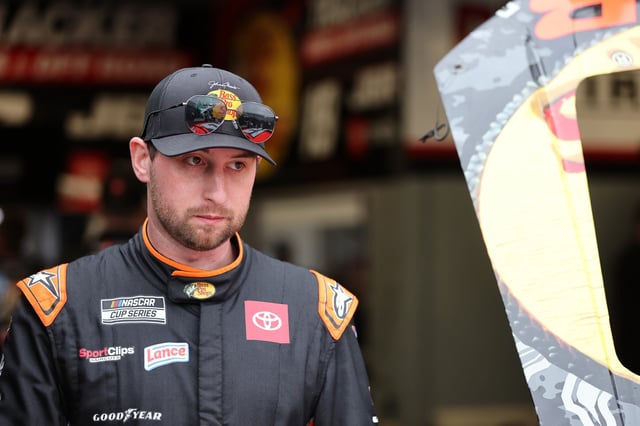 Chase Briscoe, driver of the #19 Bass Pro Shops Toyota waits in the garage area during practice for the NASCAR Cup Series Daytona 500 at Daytona International Speedway on February 14, 2025 in Daytona Beach, Florida.
