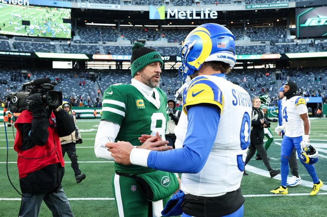 EAST RUTHERFORD, NEW JERSEY - DECEMBER 22: Aaron Rodgers #8 of the New York Jets meets with Matthew Stafford #9 of the Los Angeles Rams following the game at MetLife Stadium on December 22, 2024 in East Rutherford, New Jersey.