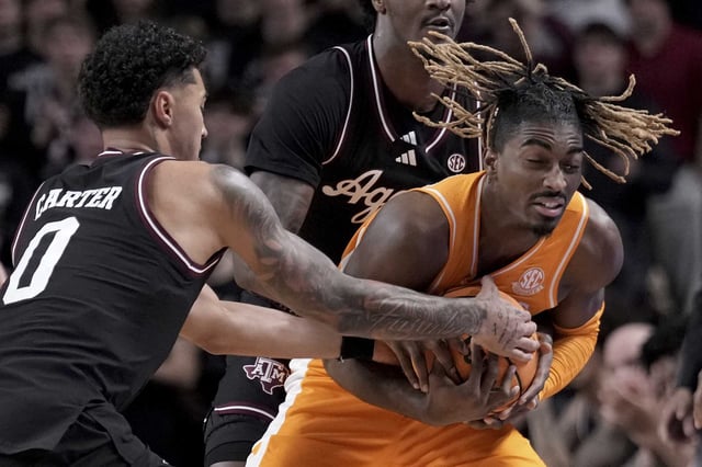 Tennessee guard Jahmai Mashack, right, is fouled after being trapped along the line by Texas A&amp;M guard Jace Carter, left, of an NCAA college basketball game Saturday, Feb. 22, 2025, in College Station, Texas. (AP Photo/Sam Craft)