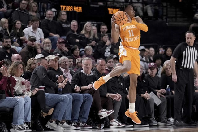 Tennessee guard Jordan Gainey (11) throws the ball back in bounds before falling out against Texas A&amp;M during the first half of an NCAA college basketball game Saturday, Feb. 22, 2025, in College Station, Texas. (AP Photo/Sam Craft)
