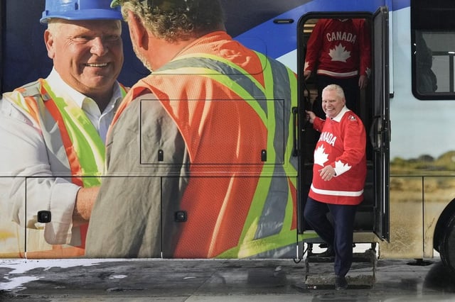 Ontario PC Leader Doug Ford steps off his campaign bus as he makes a campaign stop at HPG, a manufacturing facility in Milton, on Thursday, Feb. 20, 2025. THE CANADIAN PRESS/Chris Young