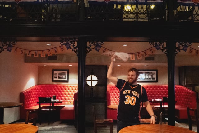 Tim Ullio, a bartender at Stout near Madison Square Garden swings his once lucky towel.