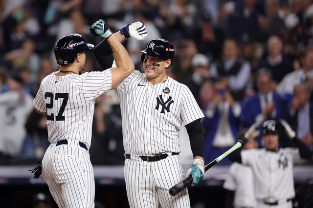 NEW YORK, NEW YORK - OCTOBER 30: Giancarlo Stanton #27 of the New York Yankees is congratulated by Anthony Rizzo #48 after hitting a solo home run during the third inning of Game Five of the 2024 World Series against the Los Angeles Dodgers at Yankee Stadium on October 30, 2024 in the Bronx borough of New York City.