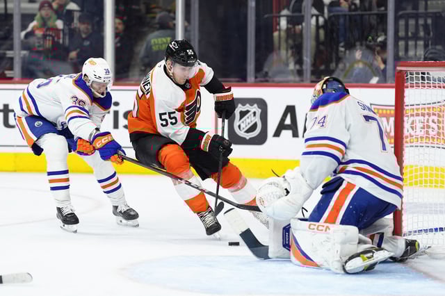 Feb 22, 2025; Philadelphia, Pennsylvania, USA; Philadelphia Flyers defenseman Rasmus Ristolainen (55) skates across the net to shoot against Edmonton Oilers defenseman John Klingberg (36) in the third period at Wells Fargo Center. Mandatory Credit: Kyle Ross-Imagn Images