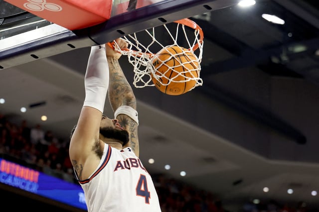 Feb 22, 2025; Auburn, Alabama, USA;  Auburn Tigers forward Johni Broome (4) completes a dunk against the Georgia Bulldogs during the second half at Neville Arena.  Mandatory Credit: John Reed-Imagn Images