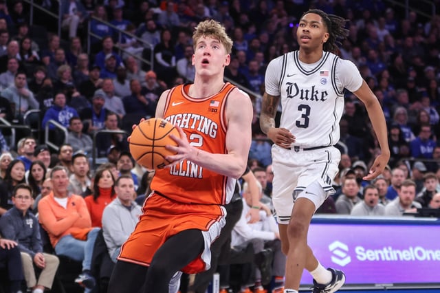 Feb 22, 2025; New York, NY, USA;  Illinois Fighting Illini guard Kasparas Jakucionis (32) drives past Duke Blue Devils guard Isaiah Evans (3) in the second half at Madison Square Garden. Mandatory Credit: Wendell Cruz-Imagn Images