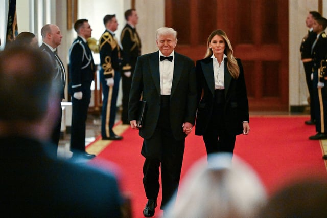 President Donald Trump and first lady Melania Trump arrive for the National Governors Association Evening Dinner and Reception in the East Room of the White House in Washington, DC, on Saturday.