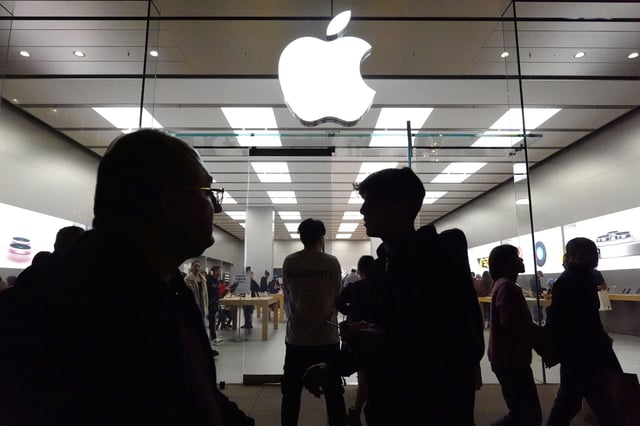 People walk by an Apple store in Glendale, California, on December 26.