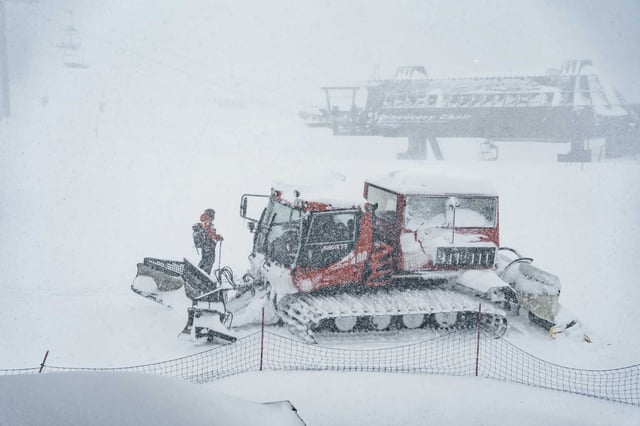 Workers plow snow during a Feb. 13 storm at Mammoth Mountain in the Sierra Nevada. Two ski patrollers were caught in an avalanche there on Feb. 14, and one has died.
 