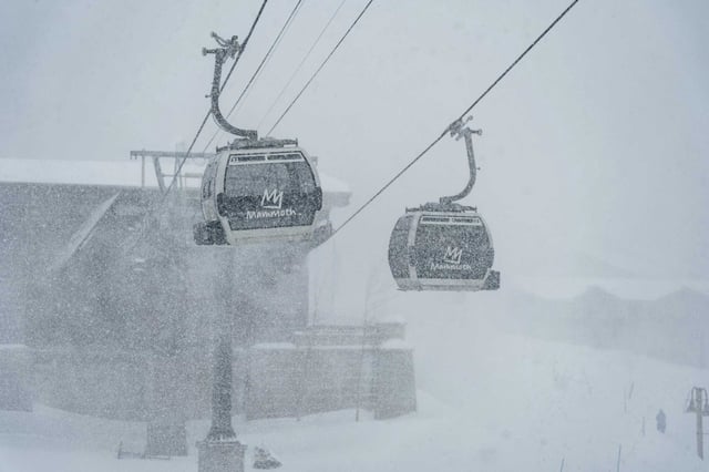 Snow falls on ski lifts during a Feb. 13 storm at Mammoth Mountain in the Sierra Nevada. A ski patroller has died of her injuries suffered in a Feb. 14 avalanche.