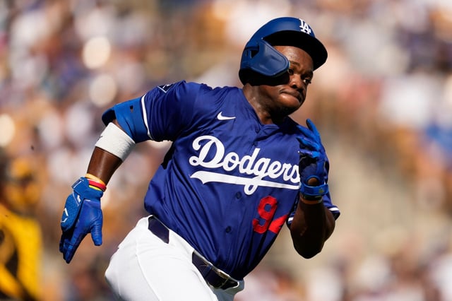 The Dodgers’ Zyhir Hope doubles during the second inning of a spring training baseball game against the San Diego Padres, Sunday, Feb. 23, 2025, in Phoenix. Austin Barnes and Miguel Rojas scored. (AP Photo/Ashley Landis)