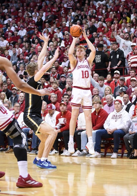 Feb 23, 2025; Bloomington, Indiana, USA; Indiana Hoosiers forward Luke Goode (10) makes a three-point basket over Purdue Boilermakers forward Caleb Furst (1) during the first half at Simon Skjodt Assembly Hall. Mandatory Credit: Robert Goddin-Imagn Images